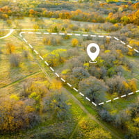 New open site with white boundary lines and center location pin
